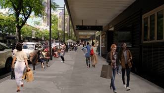 A group of people walking on a sidewalk

Description automatically generated