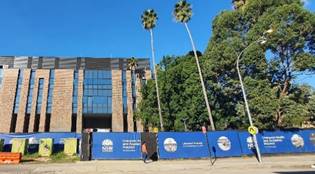 A building with trees and blue walls

Description automatically generated