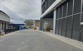 A brick road with a building in the background

Description automatically generated