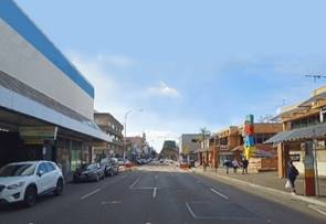 A street with cars and buildings

Description automatically generated