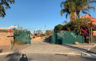 A fenced in area with trees and a fence

Description automatically generated