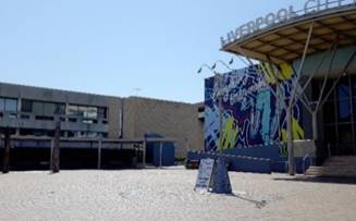 A building with graffiti on the side

Description automatically generated
