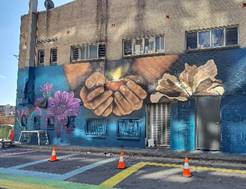 A building with a mural on the side

Description automatically generated